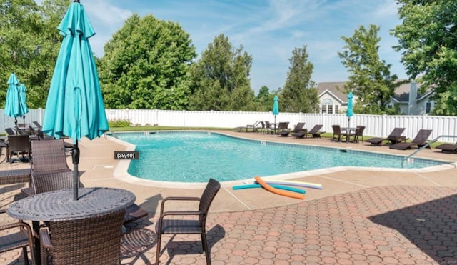 view of pool with a patio area, a fenced backyard, and a fenced in pool