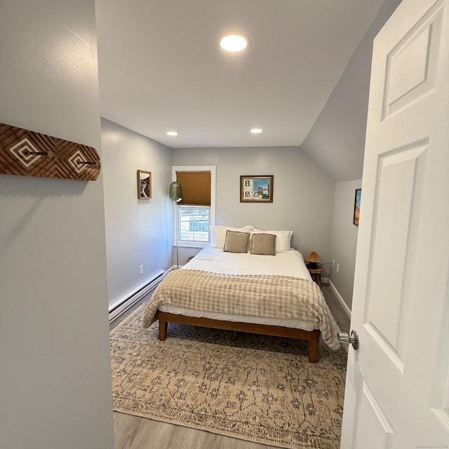 bedroom featuring a baseboard radiator, recessed lighting, vaulted ceiling, wood finished floors, and baseboards