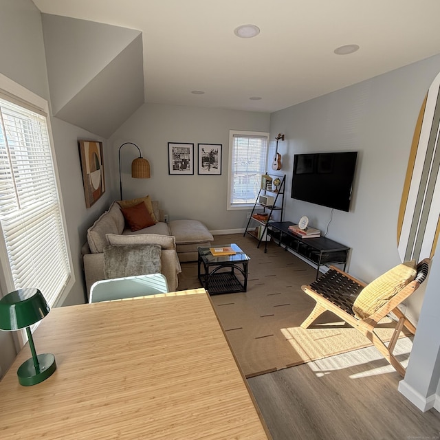 carpeted living area featuring baseboards