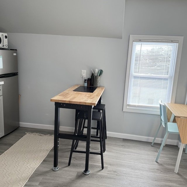 dining room featuring baseboards and wood finished floors