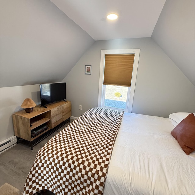 bedroom featuring a baseboard heating unit, lofted ceiling, and baseboards