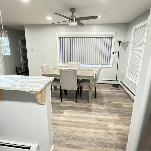 dining room featuring ceiling fan, a baseboard radiator, recessed lighting, a baseboard heating unit, and light wood finished floors