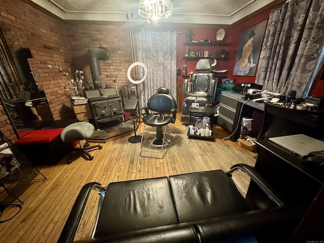 interior space featuring a wood stove, a textured ceiling, and wood finished floors