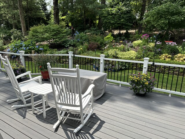 wooden deck with a lawn