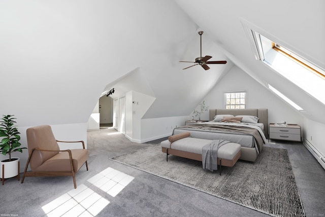 bedroom featuring lofted ceiling with skylight, carpet, ceiling fan, and baseboards