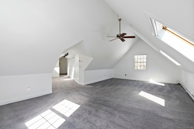 additional living space with baseboards, lofted ceiling with skylight, ceiling fan, baseboard heating, and carpet flooring