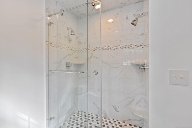 bathroom with a marble finish shower