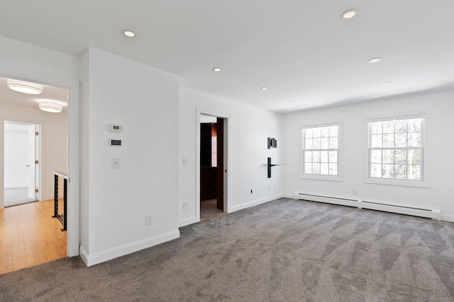 carpeted spare room with baseboards, a baseboard radiator, and recessed lighting