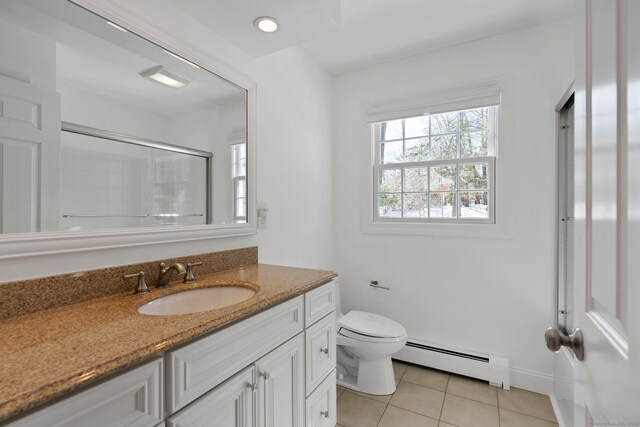 full bath featuring toilet, a shower with shower door, vanity, baseboard heating, and tile patterned floors