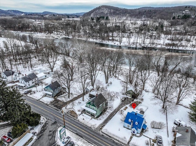 snowy aerial view featuring a mountain view