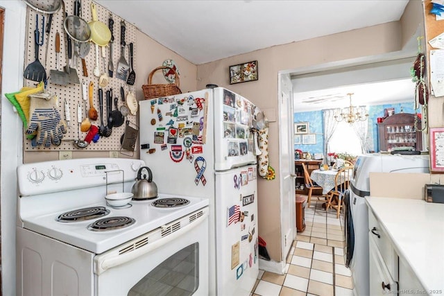 kitchen with light countertops, white appliances, and a notable chandelier