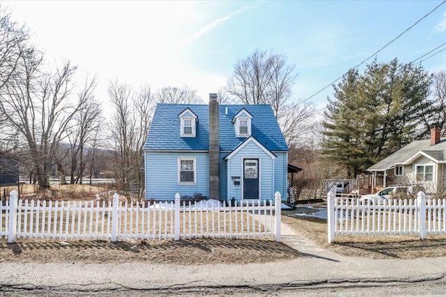 view of front facade featuring a fenced front yard and a chimney