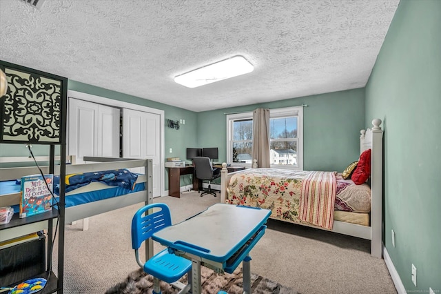 bedroom with carpet, a textured ceiling, baseboards, and a closet