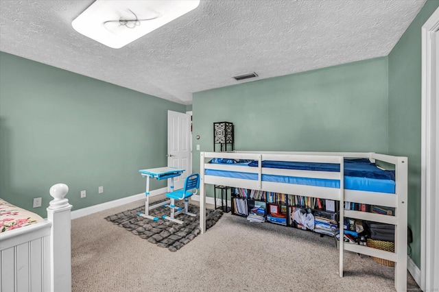 carpeted bedroom with visible vents, a textured ceiling, and baseboards