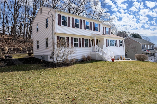 colonial-style house with a garage and a front yard