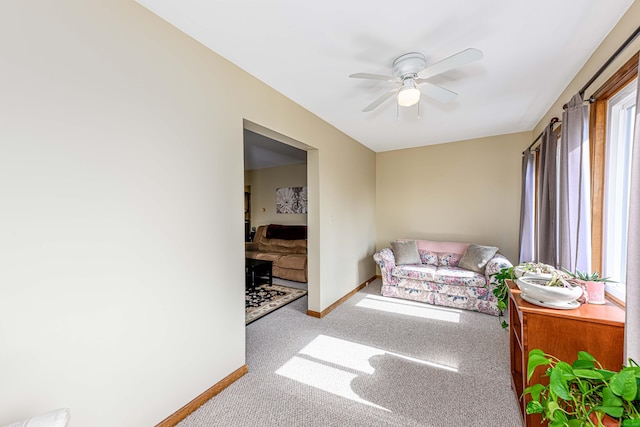 interior space featuring ceiling fan, carpet floors, and baseboards