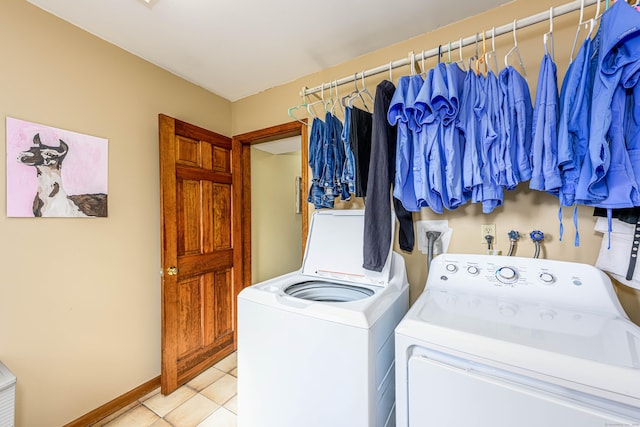 clothes washing area featuring laundry area, light tile patterned floors, baseboards, and washer and dryer