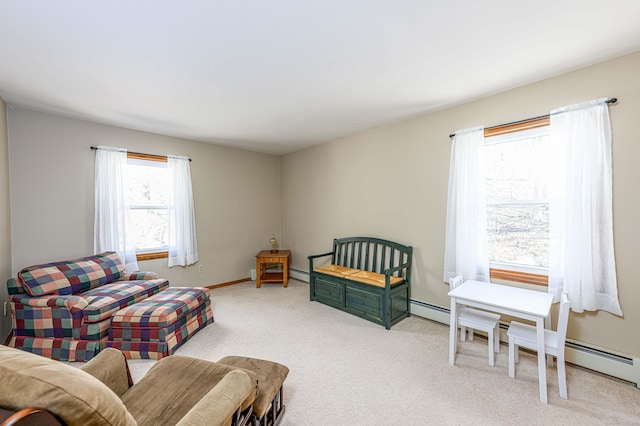 living area featuring light carpet, a baseboard radiator, and baseboards