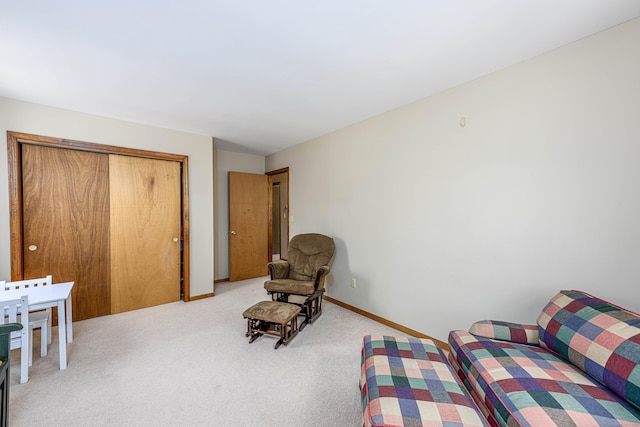 living area with baseboards and light colored carpet