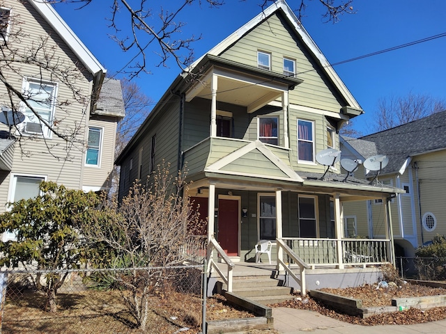 view of front of home with covered porch and fence