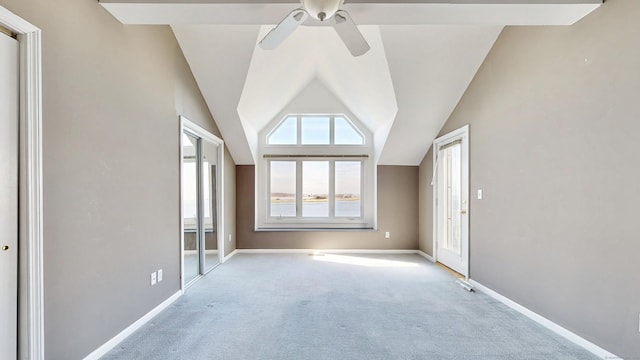 interior space with vaulted ceiling, a ceiling fan, and baseboards