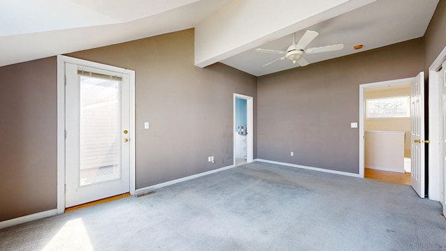 empty room with lofted ceiling with beams, ceiling fan, baseboards, and carpet flooring