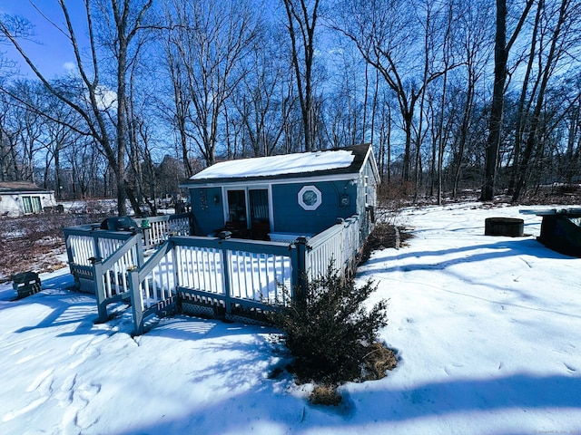 exterior space with an outbuilding and a deck