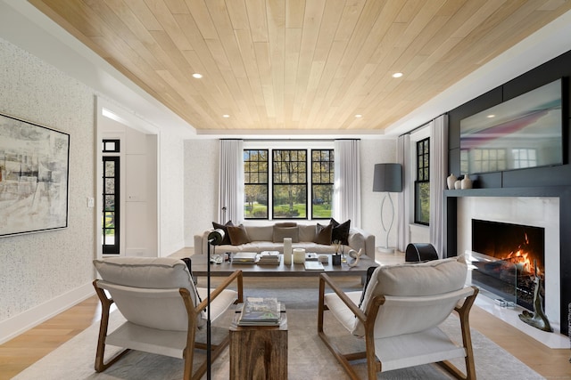 living room with wallpapered walls, wood finished floors, a healthy amount of sunlight, and wood ceiling