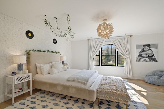 bedroom with baseboards and wood finished floors