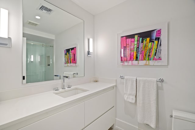 full bathroom with toilet, visible vents, a shower stall, and vanity