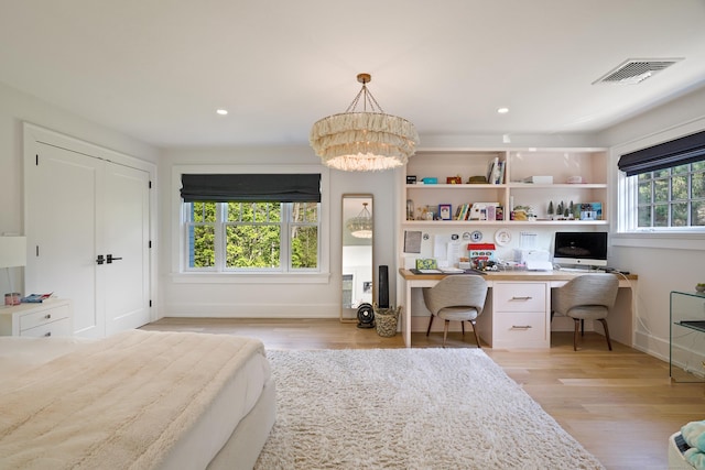 bedroom with light wood-style flooring, built in desk, visible vents, baseboards, and recessed lighting