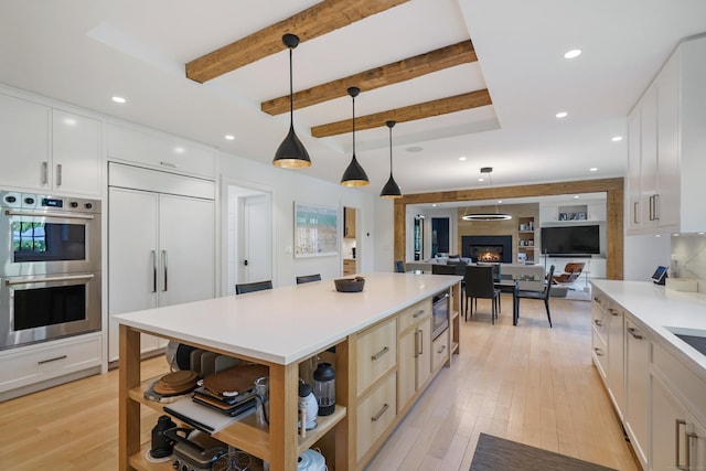 kitchen featuring stainless steel double oven, paneled built in fridge, open shelves, light wood-style flooring, and white cabinetry