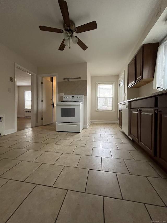 kitchen featuring white appliances, light tile patterned floors, baseboards, and dark brown cabinets