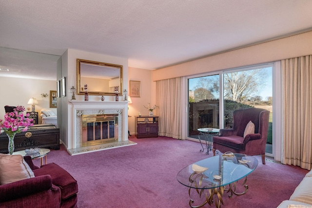 carpeted living room with a premium fireplace and a textured ceiling