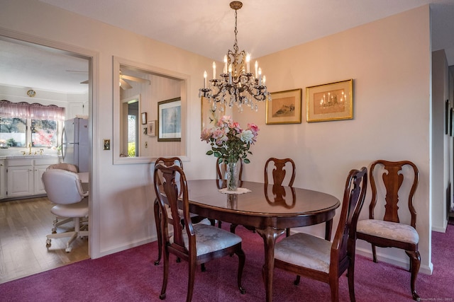 dining space with light colored carpet, baseboards, and light wood finished floors