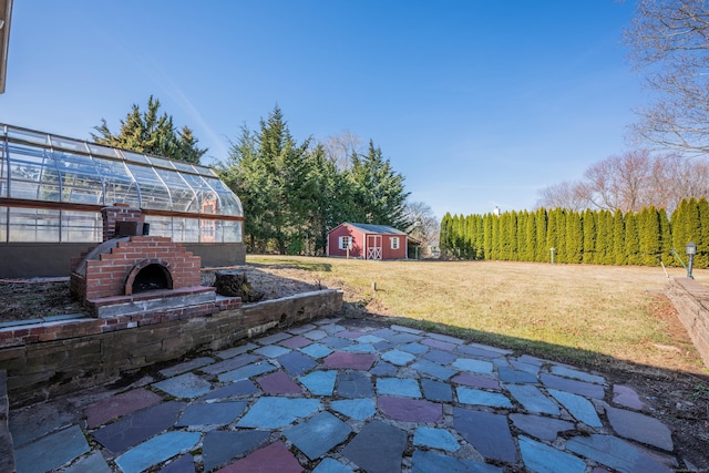 view of patio featuring an outbuilding and an exterior structure