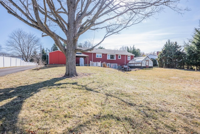 view of yard with an outbuilding and fence