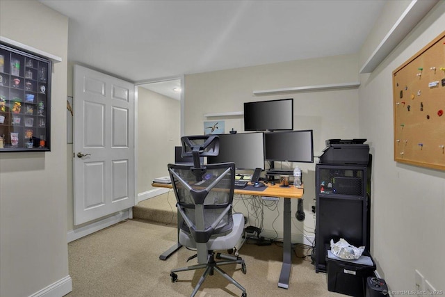 carpeted office space featuring baseboards