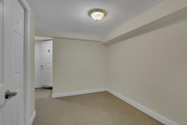 unfurnished room featuring baseboards and carpet flooring