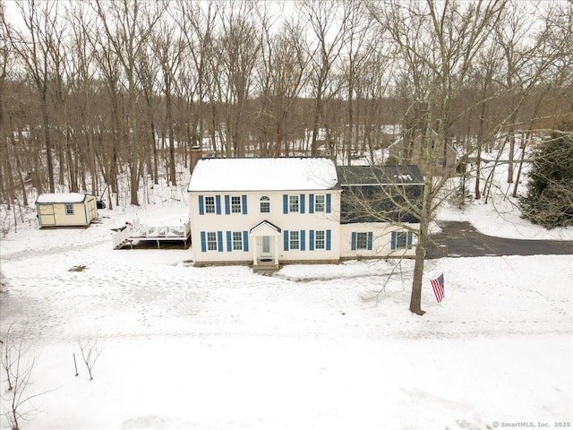 view of front of home featuring a storage shed and an outdoor structure