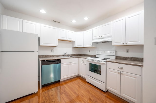 kitchen featuring under cabinet range hood, white appliances, a sink, visible vents, and white cabinets