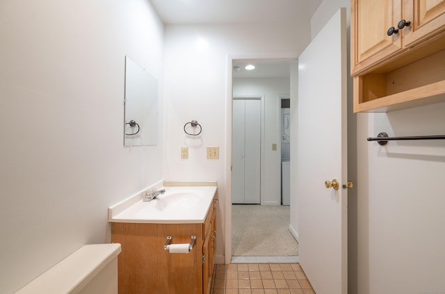 half bath featuring vanity and toilet