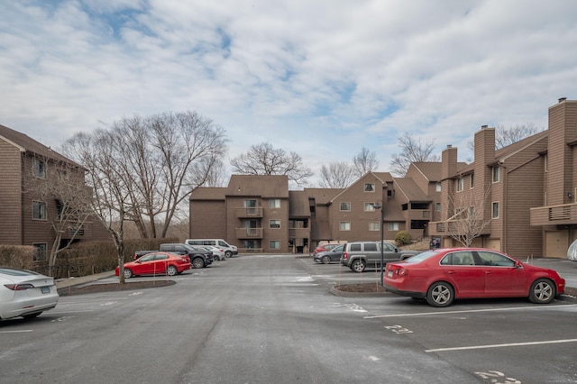 uncovered parking lot featuring a residential view