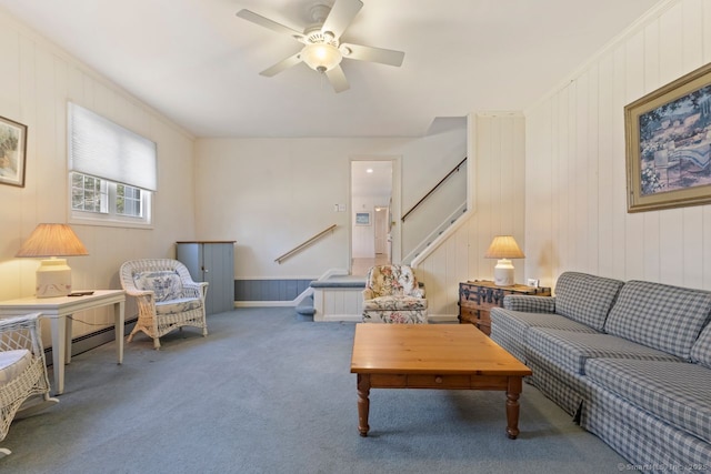 living area with stairs, carpet floors, and ceiling fan