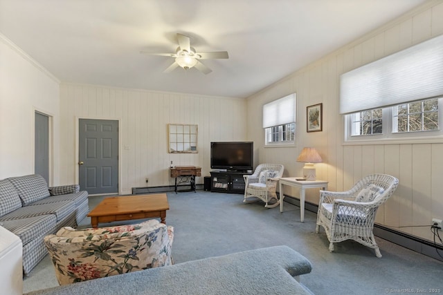 carpeted living room featuring ceiling fan, crown molding, and a baseboard radiator