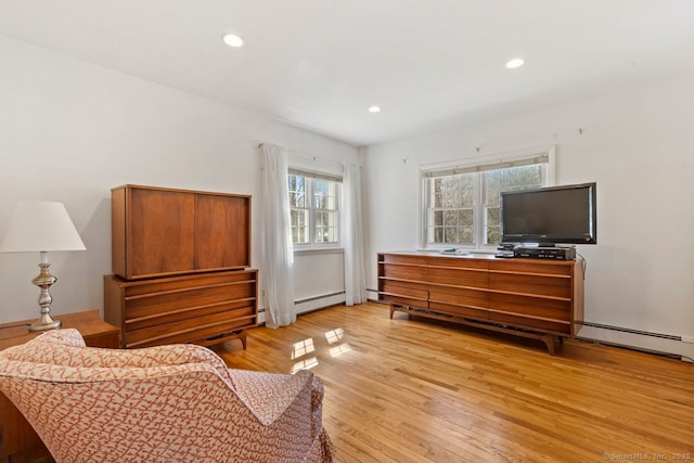 sitting room featuring recessed lighting, light wood finished floors, and a baseboard radiator