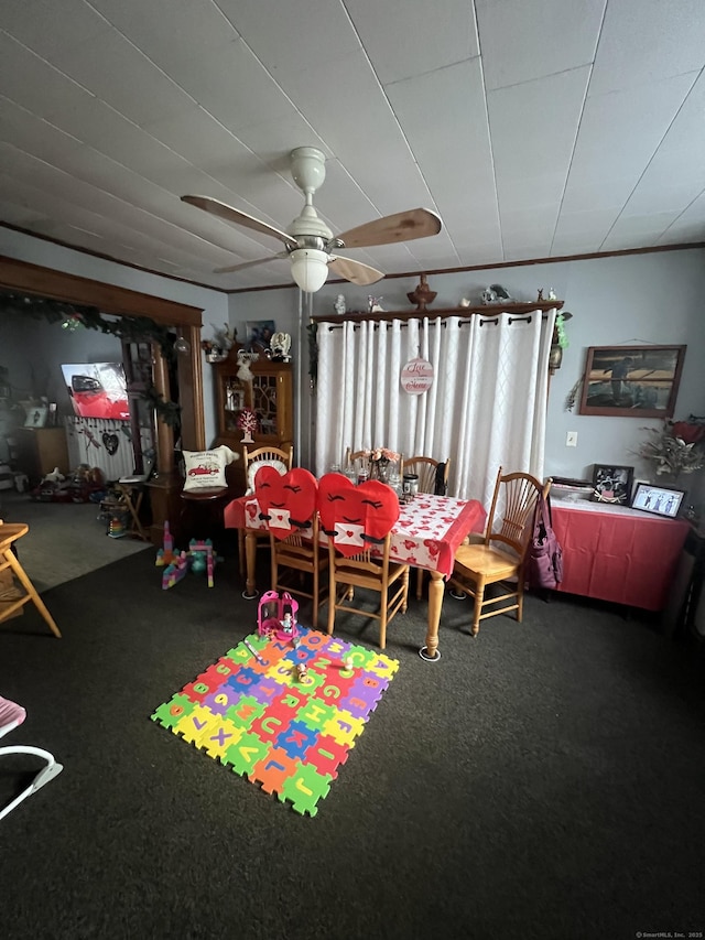 carpeted dining area with a ceiling fan