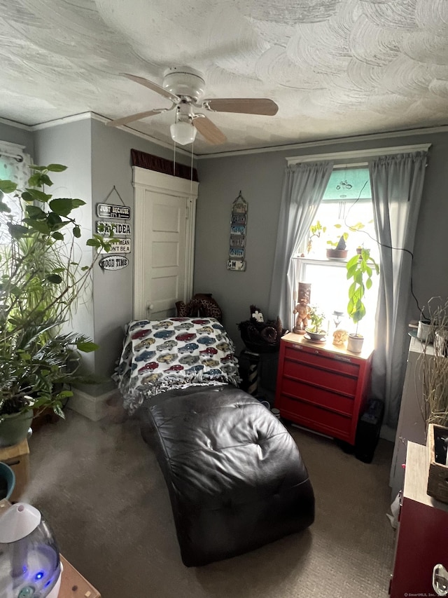 carpeted bedroom with ceiling fan, a textured ceiling, and crown molding