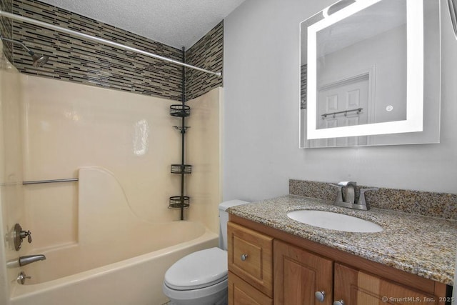 full bath with toilet, shower / bathtub combination, a textured ceiling, and vanity