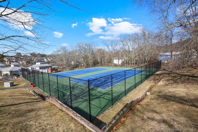 view of tennis court featuring fence